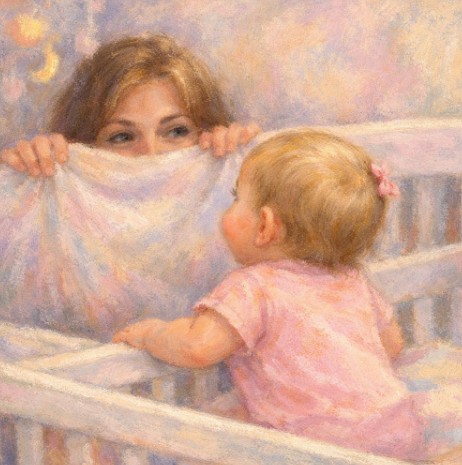 Toddler playing peek-a-boo with a small blanket